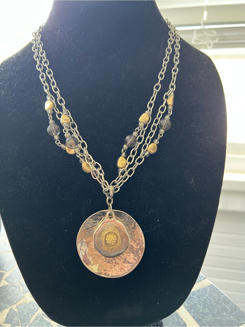 Vintage Chicos multi strand mixed metal with circular disk pendant necklace.